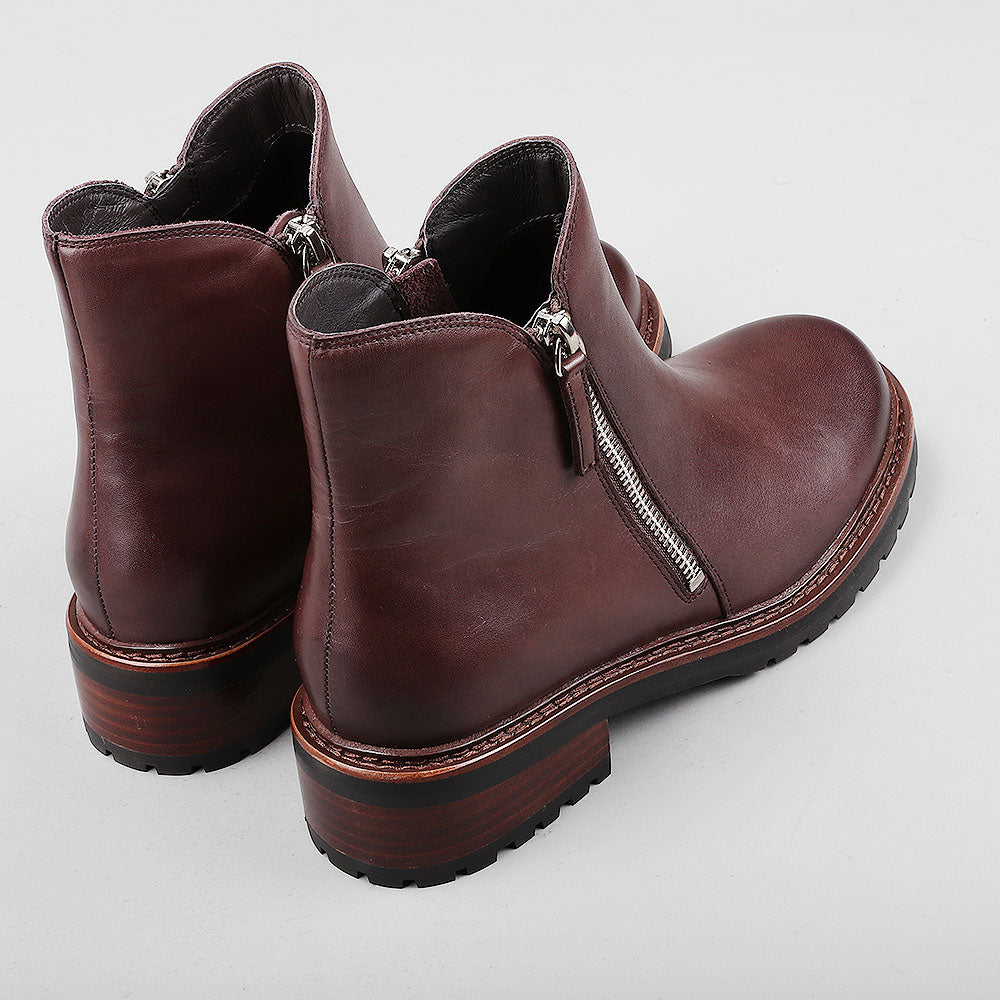 Pair of Le Sansa Cayla chocolate boots with back view, showcasing stylish design and rich brown color.