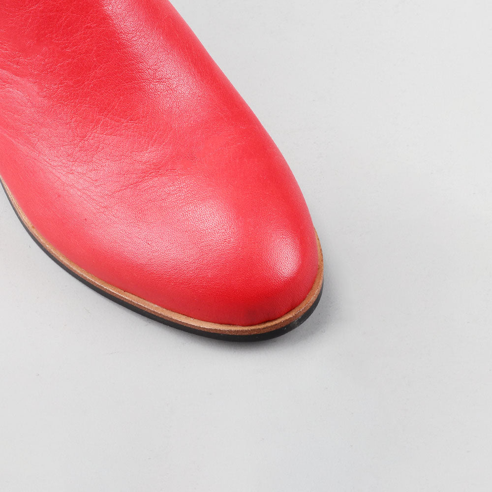 Close-up of Naked Arches Oxley Red boots showing rich red leather and detailed stitching.