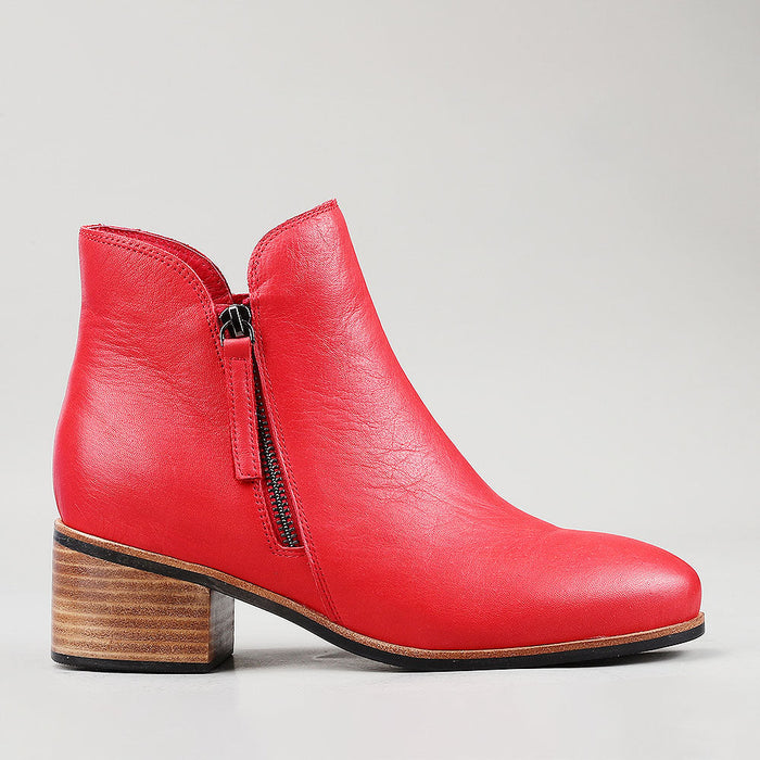 Naked Arches Oxley Red boots with a sleek design and vibrant red color, shown from the side view.
