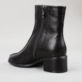 Load image into Gallery viewer, Le Sansa Spike Black boots with black leather and spike detailing, featuring a sleek, modern design and ankle-high silhouette.
