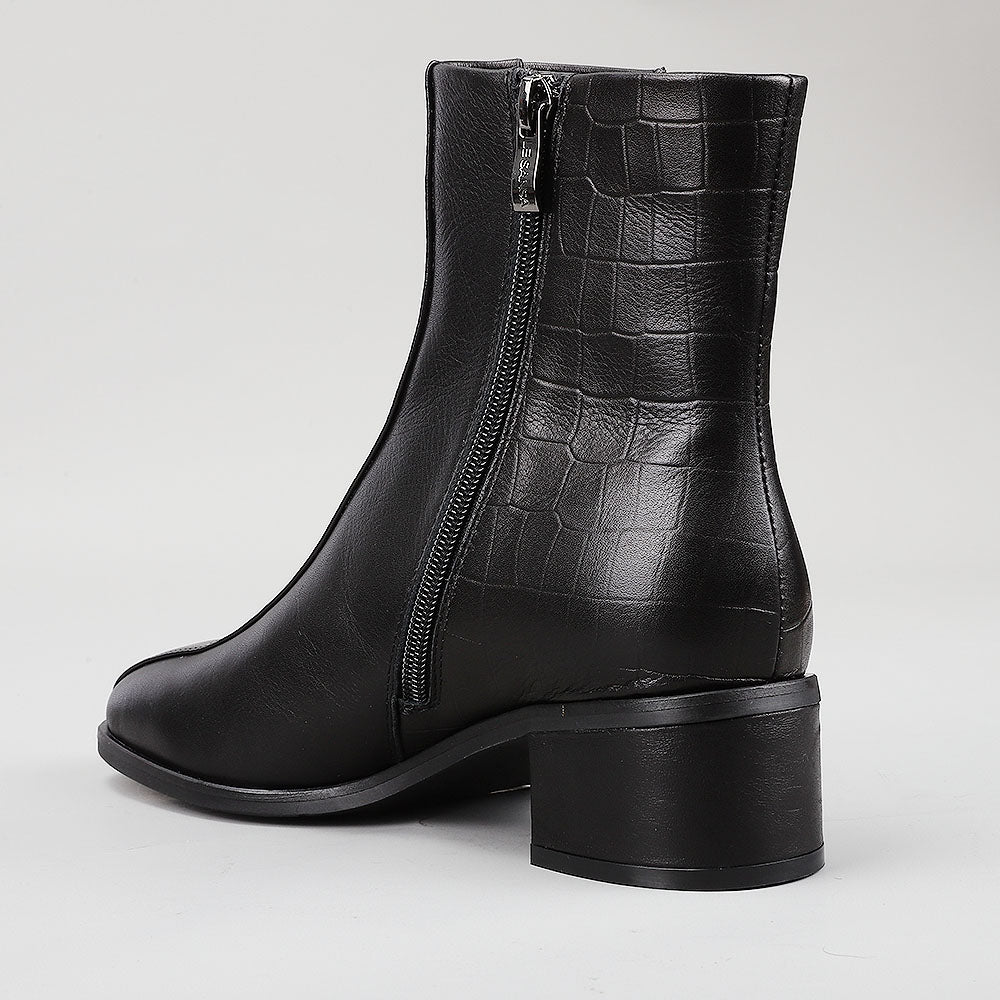 Le Sansa Spike Black boots with black leather and spike detailing, featuring a sleek, modern design and ankle-high silhouette.
