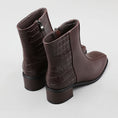 Load image into Gallery viewer, Le Sansa Spike Choco boots with chocolate-colored crocodile print, showcasing stylish, textured footwear.
